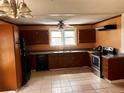 Spacious kitchen featuring dark cabinets, tile flooring, and stainless steel appliances at 3310 Pilgrim Mill Rd, Cumming, GA 30041