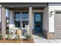 Inviting front porch with rocking chairs, stylish decor, and charming brick accents at 600 Belshire Dr, Acworth, GA 30102