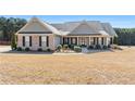 Charming single-story home featuring a manicured lawn, brick accents, and a welcoming front porch at 112 Standford Dr, Mcdonough, GA 30252