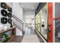 Bright foyer featuring hardwood floors, statement mirrors, and staircase with iron railings at 417 Newland Way, Acworth, GA 30102