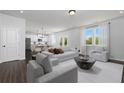 Bright, open-concept living room with modern decor, comfortable seating, and seamless access to kitchen at 608 Belshire Dr, Acworth, GA 30102