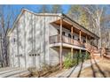 The home is perched above a drive-under garage and showcases a charming elevated front porch at 210 Joe Green Ln, Canton, GA 30114