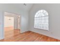 Bright, empty room with hardwood floors, white walls, and a large window at 893 Lance Cir, Lawrenceville, GA 30043