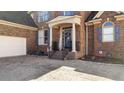 Charming brick home exterior featuring a cozy, covered entryway and adjacent garage at 108 Ardsley Run, Canton, GA 30115