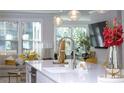 Stylish kitchen island with pendant lights and stainless steel faucet, complemented by an open-concept living area at 1322 Stanley Park Dr, Decatur, GA 30033