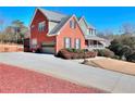 Charming exterior of home with attached garage, long driveway, and manicured landscaping at 3064 Zermatt Way, Snellville, GA 30078