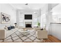 Bright living room with a fireplace, hardwood floors, and stylish decor at 2477 Misty Rose Ln, Loganville, GA 30052