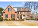 Lovely two-story brick home featuring black shutters and an inviting front lawn at 2885 Towne Village Dr, Duluth, GA 30097