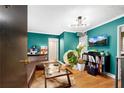 Comfortable living room featuring teal walls, hardwood floors, and modern lighting at 327 3Rd Ne St # 1, Atlanta, GA 30308