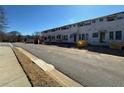 Townhomes under construction displaying multiple windows and individual entryways under a clear blue sky at 002 White St # 2, Marietta, GA 30060