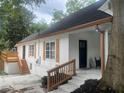 Side exterior view showcasing fresh paint, wooden shutters, and a cozy deck with stairs at 1416 Mcpherson Se Ave, Atlanta, GA 30316