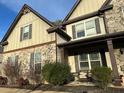 Well-maintained home featuring a stone facade and inviting covered porch at 150 Bellemeade Ct, Fayetteville, GA 30215