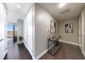 Stylish hallway featuring sleek hardwood floors, neutral walls and contemporary decor at 1820 Peachtree Nw St # 1207, Atlanta, GA 30309