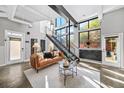 Bright living room features high ceilings, large windows, and a stylish seating area with comfortable leather sofa at 307 Cherokee Se Ave # 9, Atlanta, GA 30312