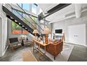 Modern living room with high ceilings, large windows, comfortable seating, and a staircase leading to the upper level at 307 Cherokee Se Ave # 9, Atlanta, GA 30312