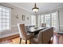 Dining room featuring wainscoting, hardwood floors, and a modern light fixture at 1459 Hedgewood Nw Ln, Kennesaw, GA 30152