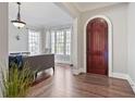 Inviting foyer featuring hardwood floors, an arched doorway, and large windows at 1459 Hedgewood Nw Ln, Kennesaw, GA 30152