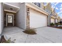 Close-up of a townhouse entrance showcasing stone accents and a well-maintained lawn at 2628 Wild Laurel Ct, Norcross, GA 30071