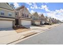 Street view showcases a row of charming townhomes with individual driveways at 2628 Wild Laurel Ct, Norcross, GA 30071