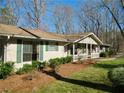 Lovely home exterior showcasing well-maintained landscaping and a welcoming front porch at 901 Guys Sw Ct, Lilburn, GA 30047