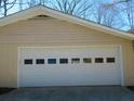 Spacious garage with a white door, offering ample storage and parking at 901 Guys Sw Ct, Lilburn, GA 30047