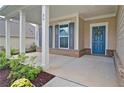 Welcoming front porch with white columns and a blue front door adorned with a decorative wreath at 39 Clubhouse Way, Acworth, GA 30101