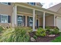 Inviting covered porch with manicured landscaping and blue shutters, creating great curb appeal at 39 Clubhouse Way, Acworth, GA 30101