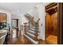 Bright entryway featuring a wooden staircase, elevator, and gleaming hardwood floors at 3633 Broughton Se Cir, Atlanta, GA 30339