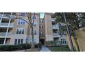 Attractive condo exterior with balconies, a lush tree, and a charming entrance at 222 Ashford Cir # 222, Atlanta, GA 30338