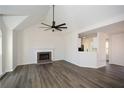 Bright living room featuring a fireplace, fan, and hardwood floors at 2971 Ruby Ct, Powder Springs, GA 30127