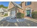 Beautiful brick home showcasing a stylish front entrance and a two-car garage at 9185 Brockham Way, Alpharetta, GA 30022