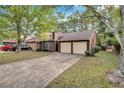 Inviting single-story home featuring a two-car garage and mature landscaping at 1522 Burnstone Dr, Stone Mountain, GA 30088