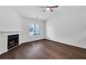 Bright living room with a cozy fireplace, ceiling fan and large window at 1522 Burnstone Dr, Stone Mountain, GA 30088