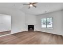 Spacious living room featuring a fireplace, a ceiling fan and a large window at 1522 Burnstone Dr, Stone Mountain, GA 30088