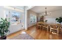 Bright dining room with hardwood floors, modern chandelier and view of the front lawn at 17 Baral Rdg, Sharpsburg, GA 30277