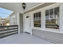 Inviting front porch with windows framing the entry, complemented by gray trim at 2006 Conrad Se Ave, Atlanta, GA 30315