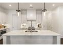 Modern kitchen with stainless steel appliances, a large island, and stylish lighting fixtures at 331 S Esplanade, Alpharetta, GA 30009