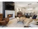 Open-concept living room with fireplace, dining area and modern decor; ideal for relaxation and entertaining at 331 S Esplanade, Alpharetta, GA 30009