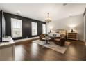 Spacious main bedroom featuring hardwood floors, a chandelier, and large windows with shutters at 331 S Esplanade, Alpharetta, GA 30009