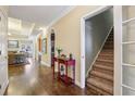 Spacious hallway with hardwood floors, leading to the living room and stairs to the upper level of the home at 172 Sweet Branch Ct, Grayson, GA 30017