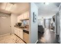 View of the entry to a living room through the kitchen and hallway. The gray living room features light floors at 3655 Habersham Ne Rd # 227, Atlanta, GA 30305