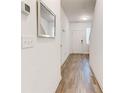 Inviting hallway with wood-look flooring, neutral walls, and modern light fixtures at 6356 Kennonbriar Ct, Lithonia, GA 30058