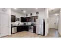 Modern kitchen featuring stainless steel appliances, dark cabinetry, and granite countertops at 6356 Kennonbriar Ct, Lithonia, GA 30058