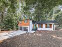 Beautiful home with cedar and brick exterior, green door, and a lush tree backdrop at 1564 Bubbling Creek Rd, Brookhaven, GA 30319