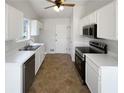 Bright kitchen with white cabinets, stainless steel appliances, and a tile floor at 1831 Killarney Sw Dr, Marietta, GA 30008