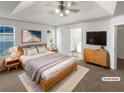 Staged main bedroom featuring a ceiling fan, an ensuite bathroom, and a walk-in closet at 1831 Killarney Sw Dr, Marietta, GA 30008