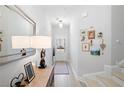 Bright entryway with a light wood floors, decorated console table, and staircase at 3037 Ferrington Way, Smyrna, GA 30080