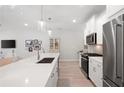 Modern kitchen with white cabinetry, stainless steel appliances and beautiful countertops at 3037 Ferrington Way, Smyrna, GA 30080