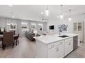 Bright open-concept kitchen and living room with recessed lighting and views from many windows at 3037 Ferrington Way, Smyrna, GA 30080