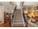 Elegant staircase with carpeted steps and ornate wrought iron railing at 3510 Estates Landing Nw Dr, Kennesaw, GA 30144